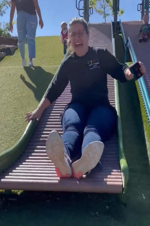 A person laughing on a roller slide