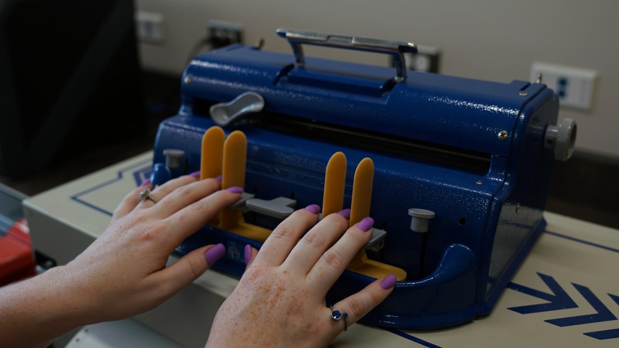 Close-up of the 3D printed finger guide being demonstrated. 