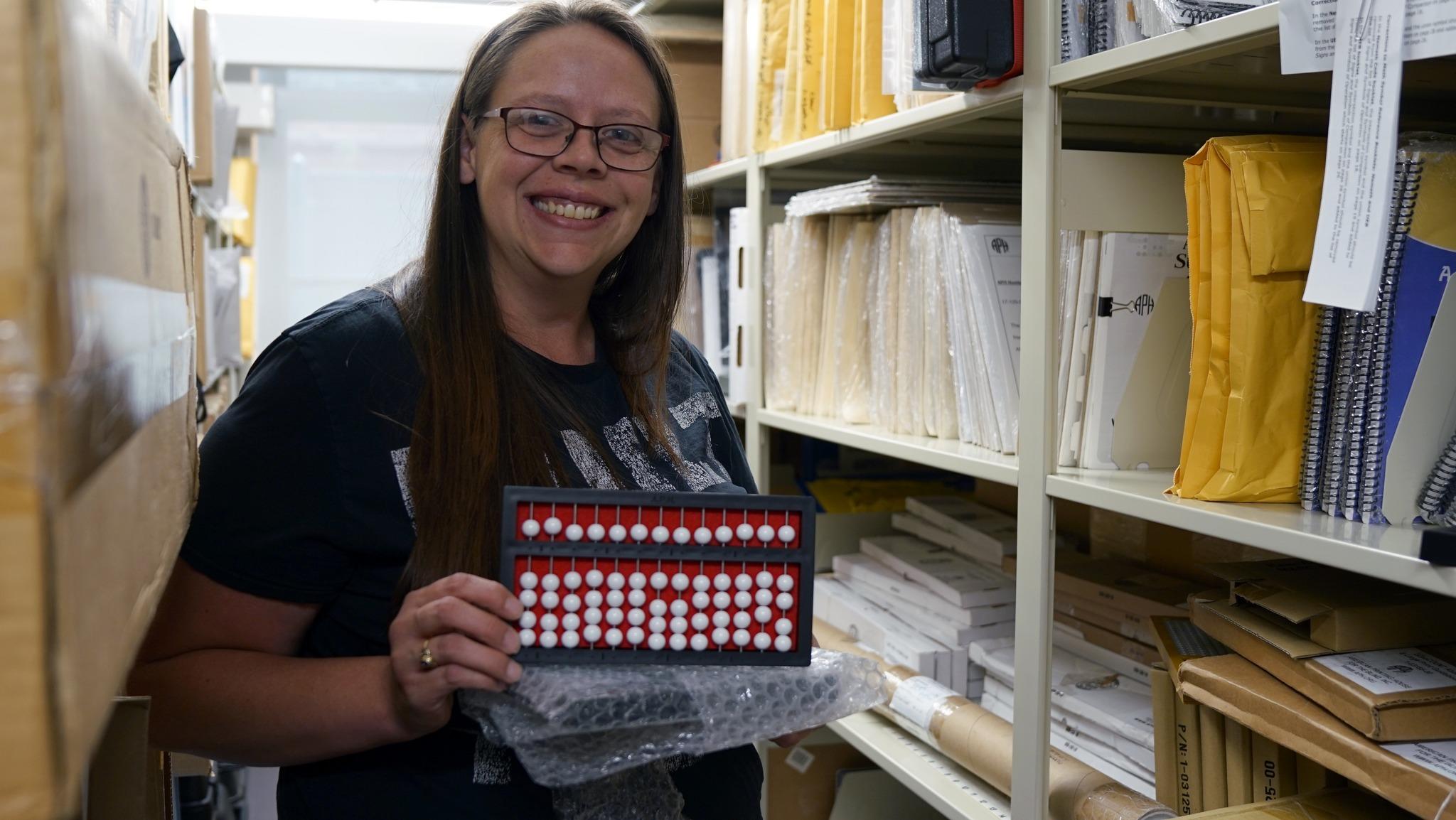 A female staff member holds an abacus. Bottom Right: A shelf full of braille text books.