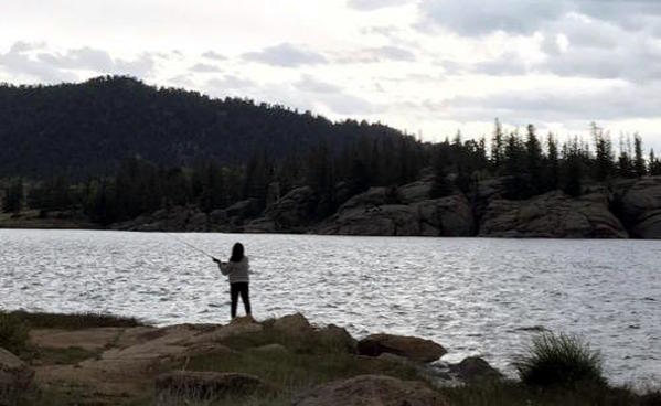 Student fishing on camping trip