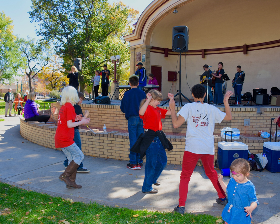 Students dancing in front of Acacia Park Bandshell