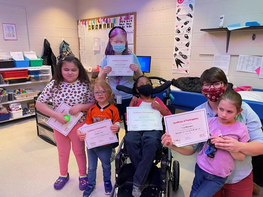 Rookie Braille Challenge class holding certificates