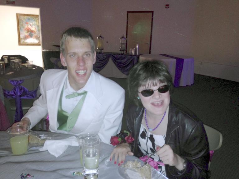 Two students eating together at prom.