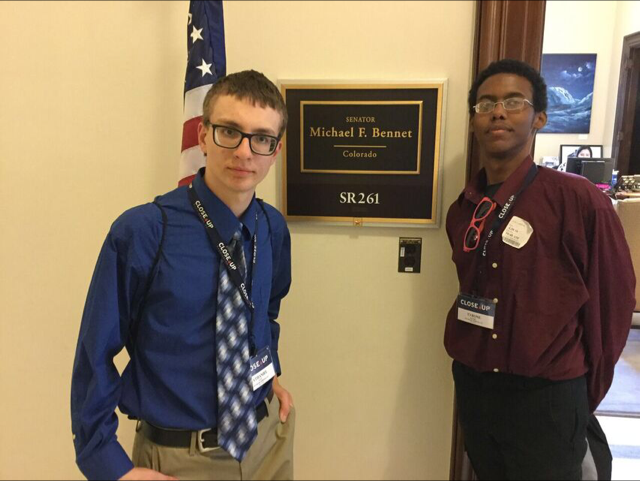 Two students stand in front of the Colorado Senator’s sign on a Close-Up trip to Washington DC.