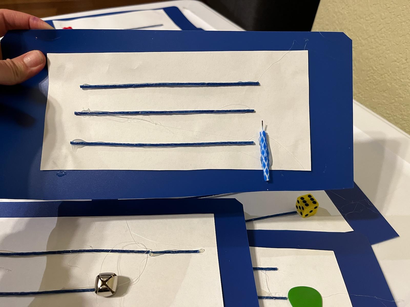 tactile lines on cardboard with item on lower right side of lines