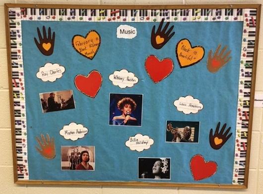 A bulletin board with Louis Armstrong, Whitney Houston, Marian Anderson, Ray Charles and Billie Holiday