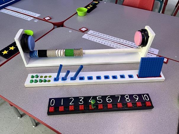 Three handmade adaptive math tools: universal counter, place value block holder, number line