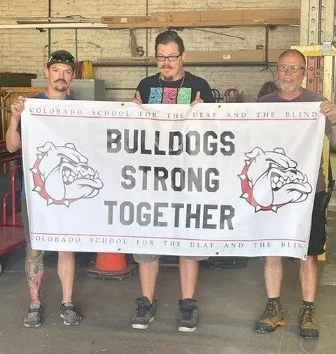 facilities staff holding a banner that reads Bulldogs Strong Together