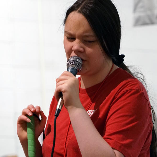 Student holds and talks into a microphone