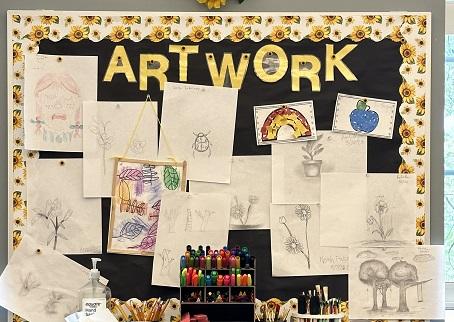 Picture of bulletin board with multiple art samples from students in class