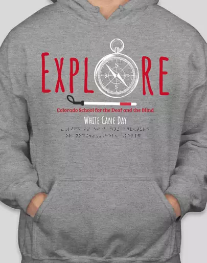 Graphic on front only.  “EXPLORE” with a compass as the “O,” below that is a horizontal white cane, below that “Colorado School for the Deaf and the Blind,” below that “White Cane Day,” below that in braille it says “Life is either a daring adventure or nothing.” – Helen Keller