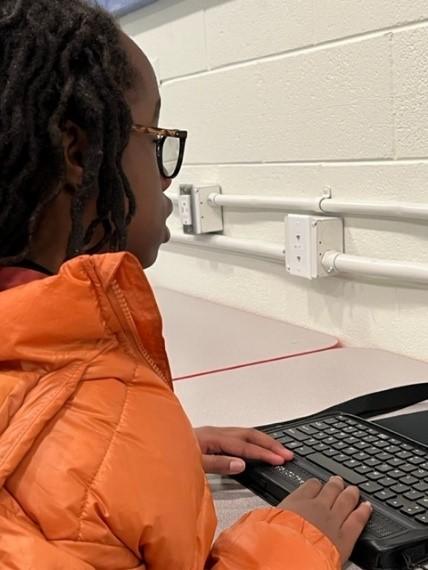 Girl uses computer keyboard