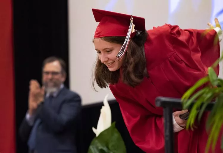 Female graduate bows on stage