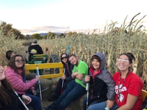 Students enjoy a hay ride at the pumpkin patch