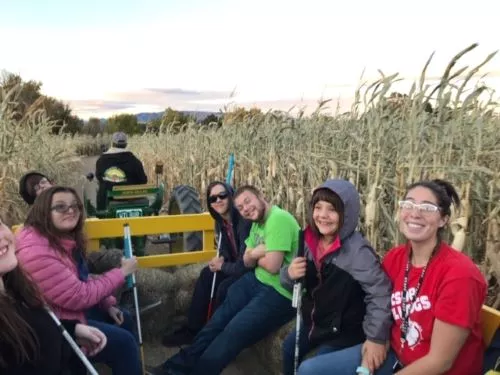 Students enjoy a hay ride at the pumpkin patch
