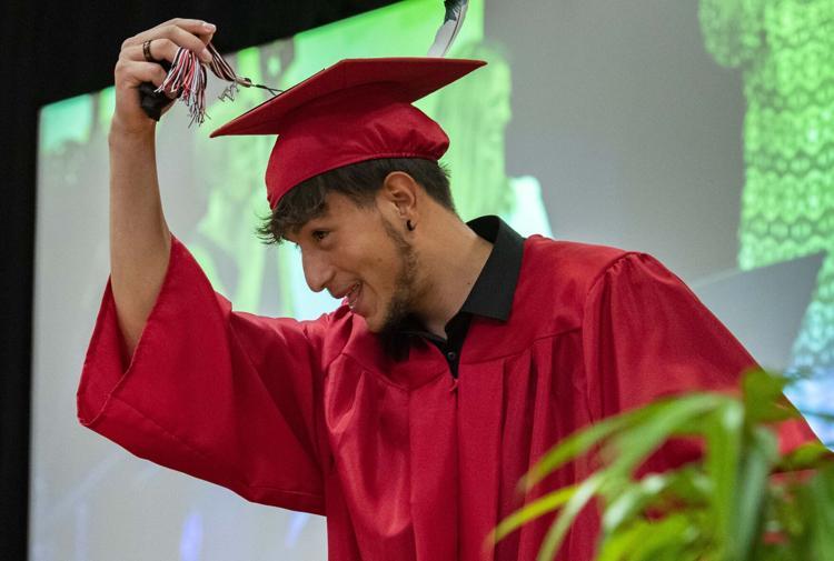 Male student moves tassel on his mortarboard
