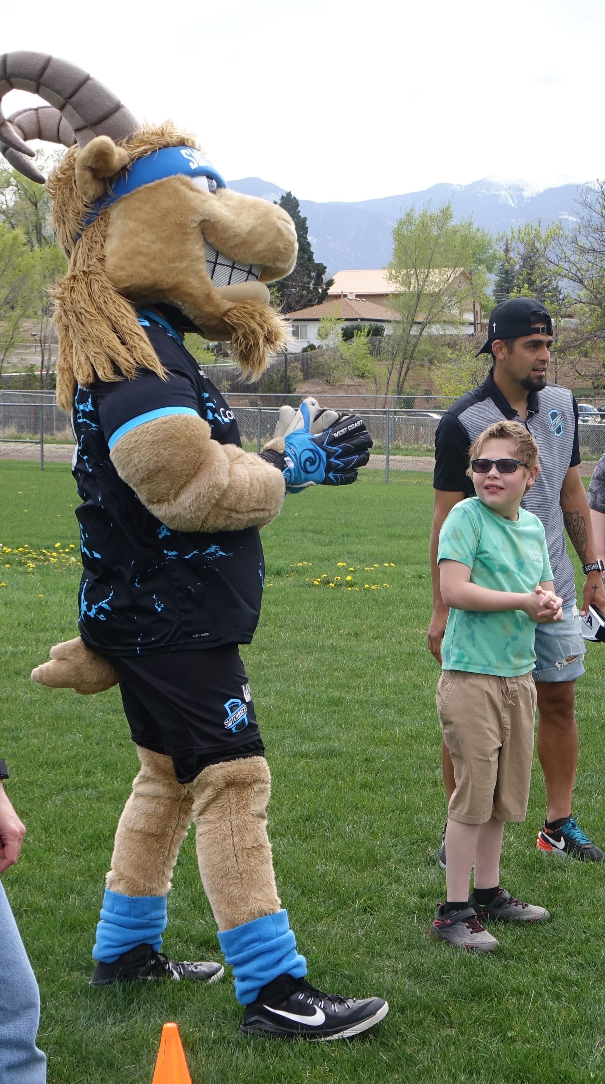 Switchbacks mascot Ziggy with young student