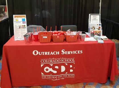 CSDB Outreach Services table in the EHDI exhibit area contains many giveaways and flyers.