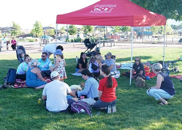 families sitting under a gazebo