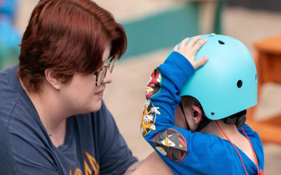 Preschool Parent and Child Putting on a Bike Helmet