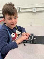 Boy using refreshable braille