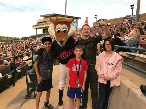 Students at Vibes baseball game posing with a fox mascot.