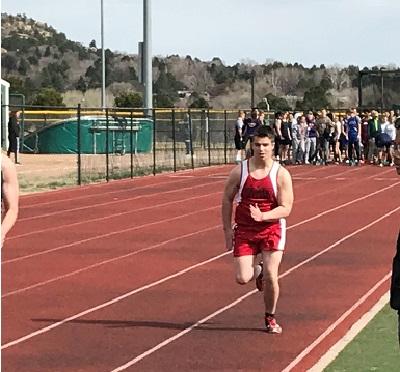 Athlete competing in race at a track meet.