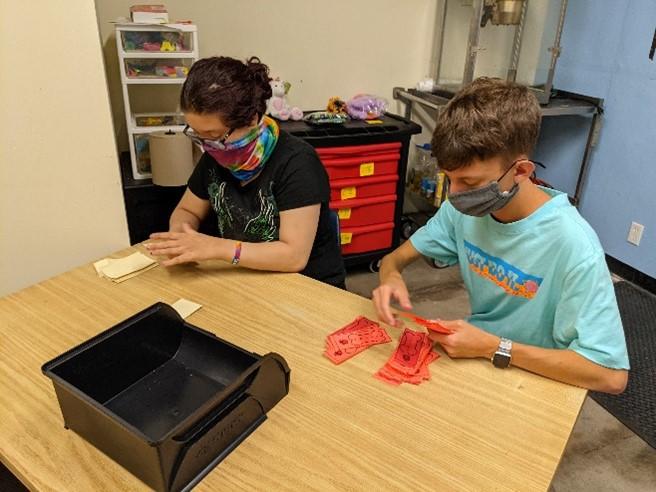 Two BtL students prepare the PRIDE store tickets and more