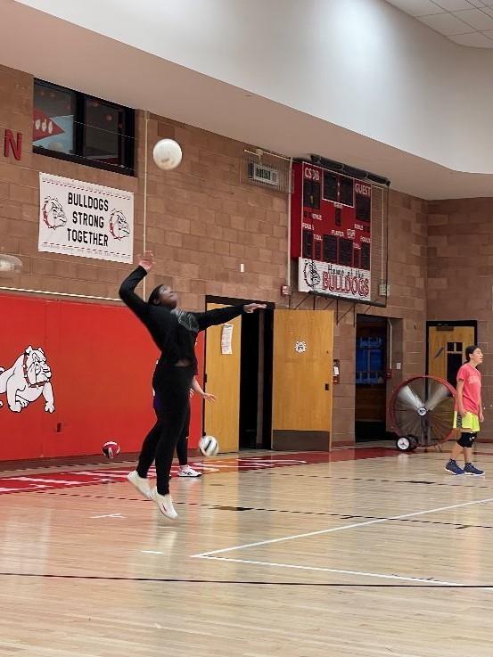 A student in the CSDB gum hitting a volleyball