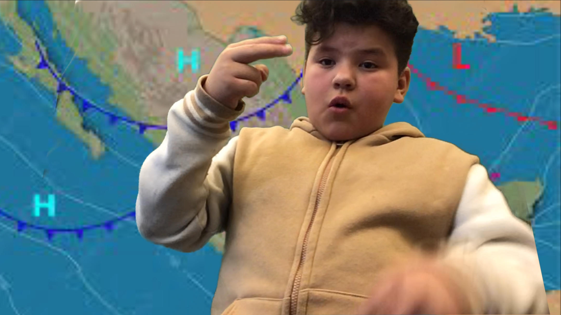 Student is signing the weather report in front of a green screen and in front of a weather map of Mexico.