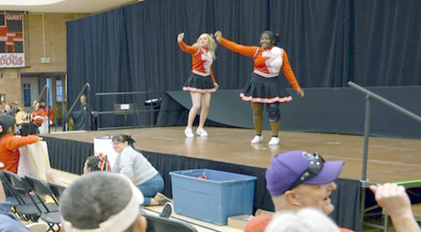 two cheerleaders perform on the stage