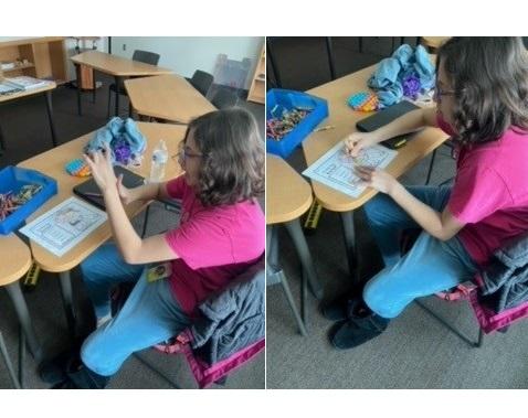 Student uses math manipulatives to work on a math sheet