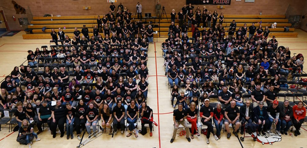 group photo of students, staff and alumni taken looking down at the group