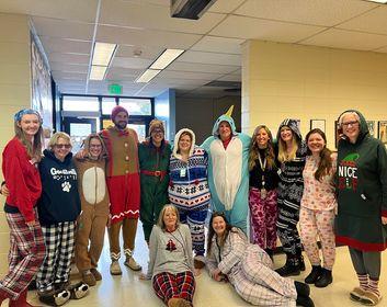 13 staff members pose for the photo while in PJs.