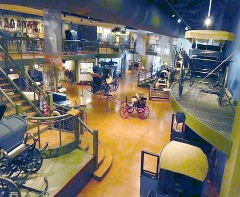 Inside of the Broadmoor Hotel.  Several old horse drawn carriages on display.