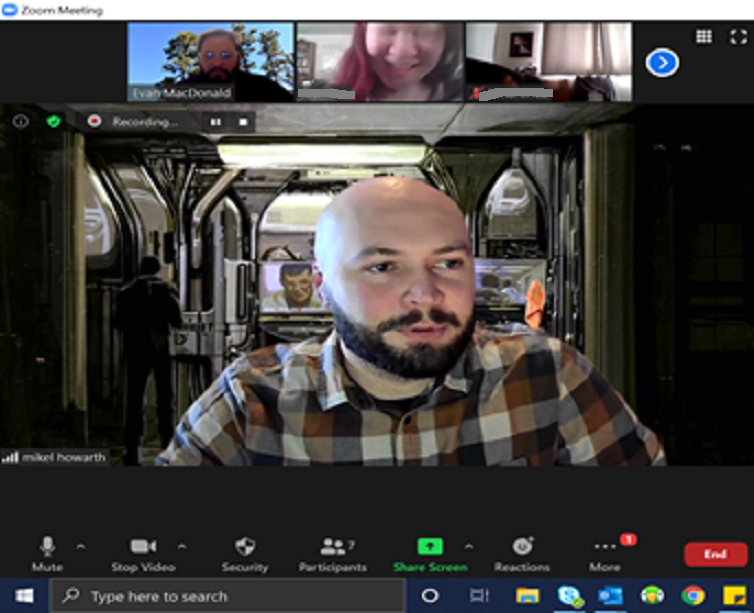 Man on Zoom in discussion with students and teacher